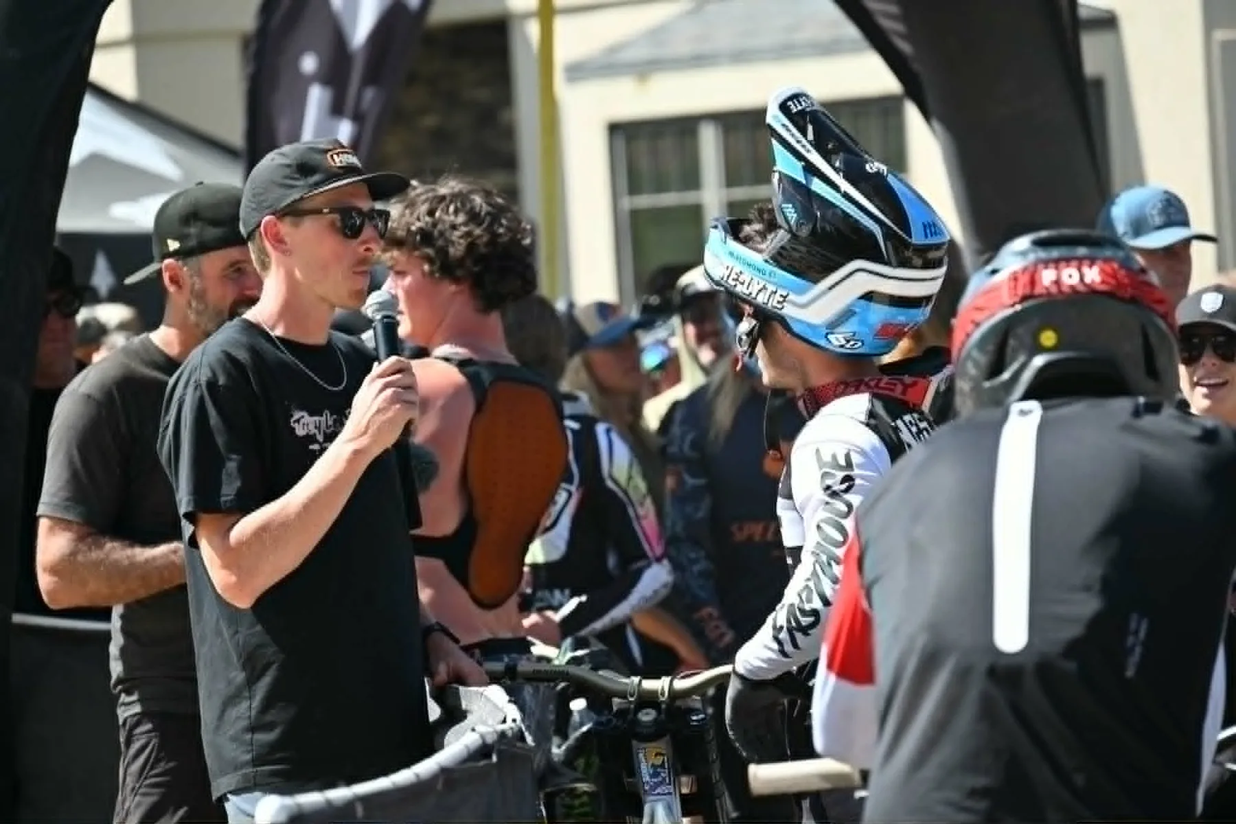 On-site host interviewing a downhill mountain bike athlete