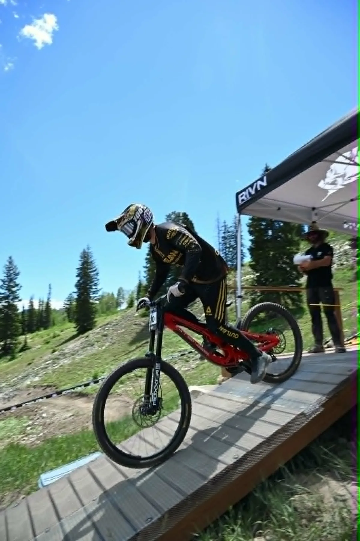 Downhill mountain bike racer leaving the start gate